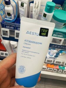 AESTURA Atobarrier 365 Cream 80ml tube held at the AESTURA derma section of an Olive Young store in Seoul